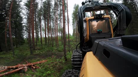 POV-gopro-shot-from-Harvester-working-in-nordic-woods,-shot-with-DJI-Osmo-Action-4