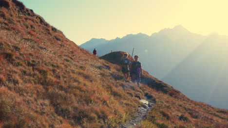 Tourists-Hiking-and-Walking-Along-Mountainous-Pathway-Trail-in-Italian-Alps-in-Autumn-Season