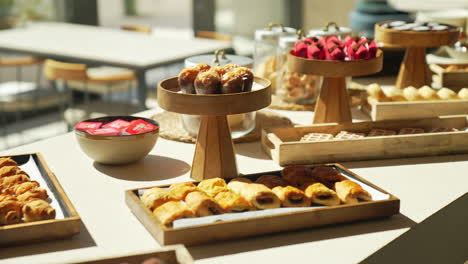 Enjoy-a-lavish-pastry-table-at-a-hotel-brunch-with-glamorous-cakes-and-croissants-beautifully-lit-by-sun