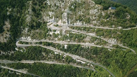 A-switchback-road-climbs-the-mountainous-region-of-Pian-della-Fioba-in-the-locality-of-Massa,-Italy