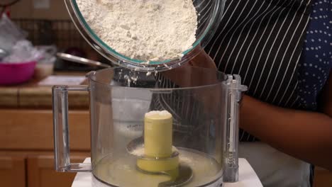 Sifting-flour-into-a-food-processor-to-mix-dough---Chana-Masala-series