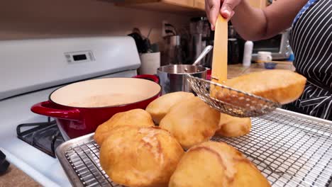 Scooping-Indian-bhatura-frybread-puffs-out-of-the-hot-oil---Chana-Masala-series
