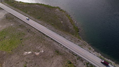 Cars-Driving-Along-Riverside-Road-Towards-Geirangerfjord-in-Geiranger-Area-in-Norway,-Aerial-View