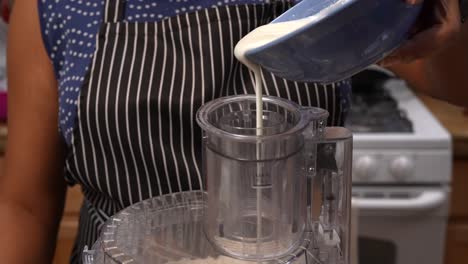 Pouring-yogurt-into-a-flour-mixture-to-make-bhatura-bread-dough---Chana-Masala-series