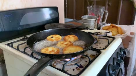 Woman-cooking-potato-cakes-in-oil-mexican-food