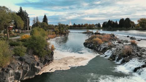 Snake-River,-Idaho-Falls-With-Mormon-Church-In-The-Background-In-USA