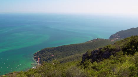 Scenic-overlook-over-the-steep-hills-towards-the-Atlantic-Ocean-from-Portinho-da-Arrábida,-Portugal
