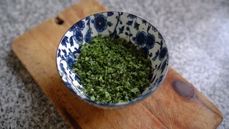 Finely-Chopped-Parsley-In-A-Ceramic-Blue-Bowl