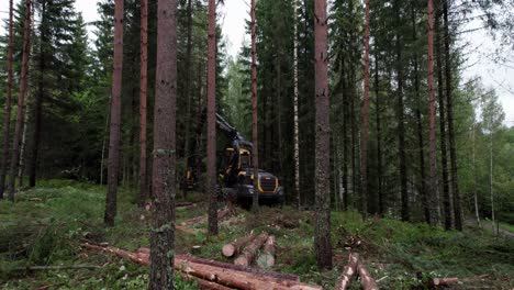 Aerial-approaching-shot-of-Scandinavian-finnish-forest-and-forestry-machine-Ponsse-Scorpion-harvester,-shot-with-DJI-Air-2s