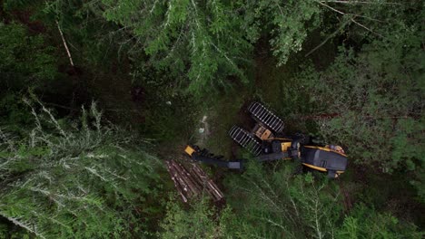 Aerial-shot-from-above-of-Scandinavian-finnish-forest-and-forestry-machine-Ponsse-Scorpion-harvester,-shot-with-DJI-Air-2s