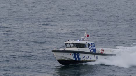 Maritime-police-boat,-coast-guard,-advancing-rapidly-in-the-Bosphorus,-police-officers-saving-people