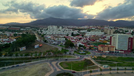 Drone-view-of-Algeciras,-Spain,-as-the-sun-sets-over-the-city