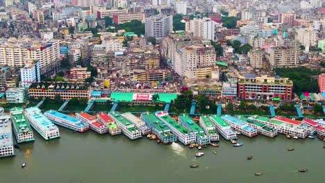 Aerial-of-vibrantly-colored-ferry-ships-docked-on-the-Buriganga-River