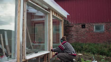 A-Man-is-Constructing-the-Frame-for-the-Glass-Window-of-the-Greenhouse