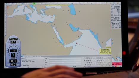 Captain-plans-route-on-ECDIS-system-through-Indian-Ocean,-Red-Sea-to-Suez,-past-Yemen