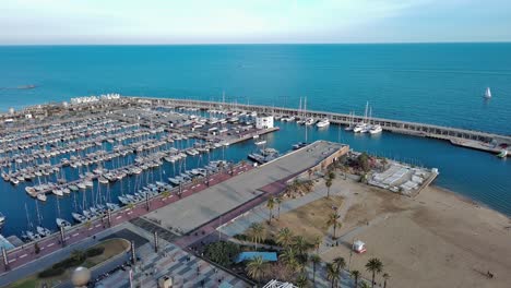 Aerial-view-of-Barcelona-Olympic-Port-and-Mapfre-Tower,-Boats-parked