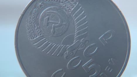 Hyper-macro-shot-of-an-old-metal-Russian-5-Ruble-coin,-CCCP-SSSR-symbol,-vintage-money,-cinematic-4K-video-pan-left