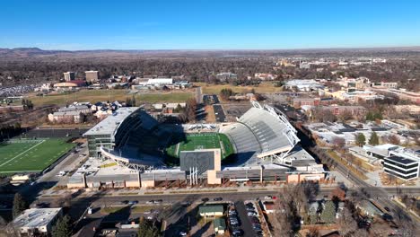 Reverse-Aerial-Drone-Reveal-of-Colorado-State-University-College-Campus-with-Football-stadium-and-student-dorms-in-Fort