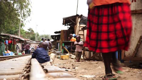 Woman-walking-on-the-railway-in-Kibera