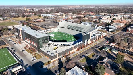 Low-drone-flyover-reversing-over-Colorado-State-university-Football-stadium-in-the-town-of-Fort