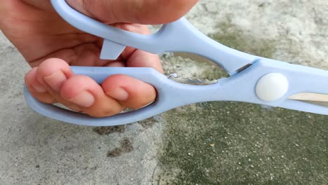 close-up-of-hand-holding-scissors