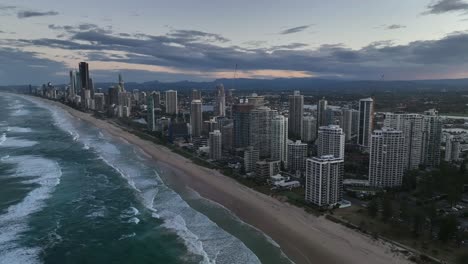 Gold-Coast,-Surfers-Paradise,-Queensland,-Australia,-drone,-Luxury-high-rise-apartments-aglow-at-sunset