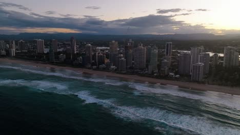 Gold-Coast,-Surfers-Paradise,-Queensland,-Australia,-drone,-High-rise-bathed-in-sunset-colors,-colours