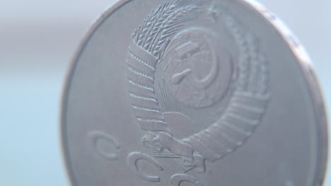 Hyper-macro-shot-of-an-old-metal-Russian-5-Ruble-coin,-CCCP-SSSR-symbol,-front-side,-vintage-money,-slow-cinematic-4K-video-pan-left