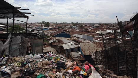 Big-pile-of-trash-and-view-of-Kibera's-tin-roofs
