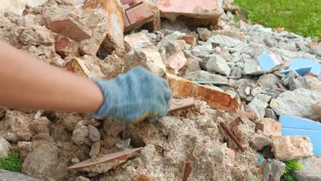 close-up-of-hands-cleaning-sandstone-debris