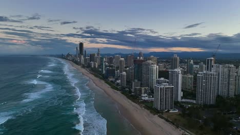 Gold-Coast,-Surfers-Paradise,-Queensland,-Australia,-drone,-Golden-cityscape-at-sunset