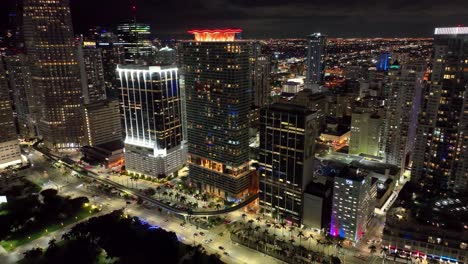 Nighttime-magic-in-Miami,-showcasing-the-city's-skyline-with-landmark-buildings-and-active-traffic