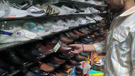 POV-SHOT,-Lots-of-young-boys-shopping-in-sport-shoes-shop