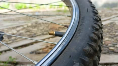 close-up-of-opening-the-lid-of-a-bicycle-tire-valve