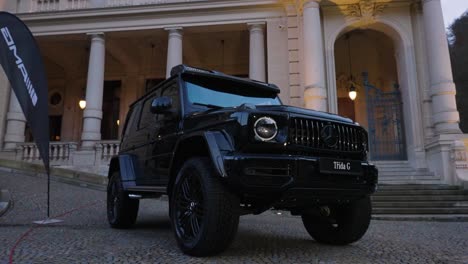 Black-Mercedes-AMG-G-63-car-parked-at-luxurious-Kaiserbad-building-driveway