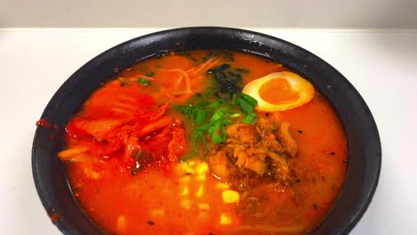 Close-up-of-different-ingredients-of-miso-Ramen-Asian-noodle-soup-handheld