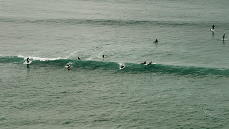 Surfers-catch-some-waves-off-the-California-coast-near-San-Diego,-California