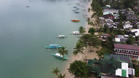 Colorful-Boats-and-tropical-fishing-village-in-early-morning,-Port-Barton