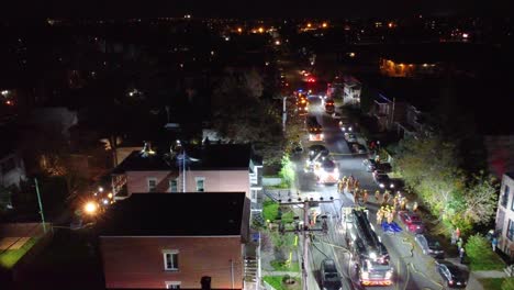 nighttime-aerial-view-of-a-residential-area-with-emergency-services-responding-to-an-incident