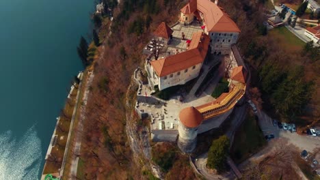 Drone-rotating-left-flying-view-of-lake-Bled-castle-on-cliff