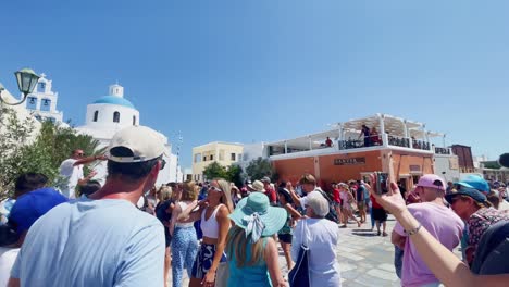 Oia-Santorini-Greece-Island-Travel-Tourist-Immersive-Walk,-Europe,-4K-|-Greek,-Aegean,-Sea,-Cliffside,-Ocean,-City,-Vacation,-Shopping,-White,-Marble,-Crowd,-Flowers,-Traveler,-People,-Overlook,-Busy