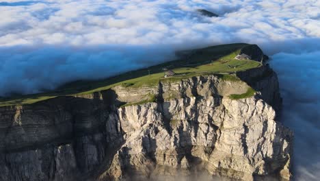 Seceda-mountain-in-the-clouds-filmed-with-drone-during-sunrise-in-the-Italian-Alps,-Dolomites