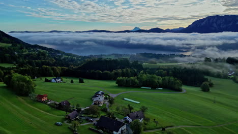 The-village-of-Austria-Attersee-is-truly-captivating,-with-its-stunning-scenic-view-in-the-valley,-The-pristine-white-clouds-that-hover-above-further-enhance-the-ethereal-charm