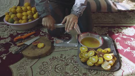 Travel-to-desert-town-to-taste-fresh-organic-orange-juice-the-healthy-drink-from-mineral-water-irrigation-orchard-garden-in-Iran-Nayband-handmade-manmade-pressure-juice-cut-in-half-squeeze-fruit