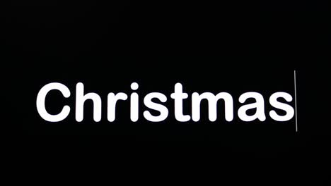 Text-written-on-black-screen-with-the-word-Christmas-in-white