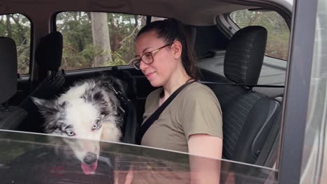 Woman-and-her-dog-ready-to-leave-in-their-car-after-going-for-a-walk