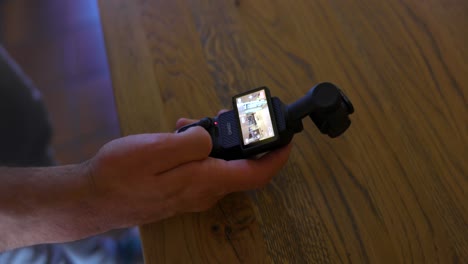 Close-up-of-active-DJI-Osmo-Pocket-3-stabilized-handheld-mobile-camera-with-touchscreen-activated