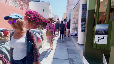 Oia-Santorini-Greece-Island-Travel-Tourist-Immersive-Walk,-Europe,-4K-|-Greek,-Aegean,-Sea,-Cliffside,-Ocean,-City,-Vacation,-Shopping,-White,-Marble,-Crowd,-Flowers,-Traveler,-People,-Colorful-Flower