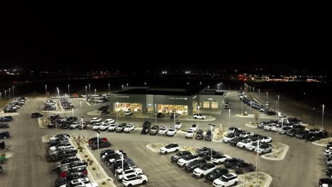 Jaguar-and-Land-Rover-luxury-car-dealership---nighttime-push-in-aerial