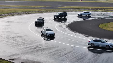 Multiple-Mercedes-cars-enter-safe-driving-school-weather-simulation-track